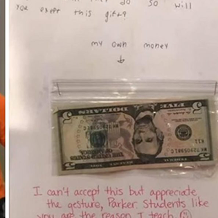 boy gives money to teacher