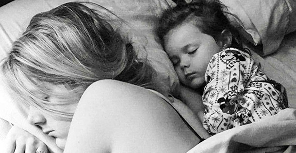 Husband takes photo of woman and daughter sleeping